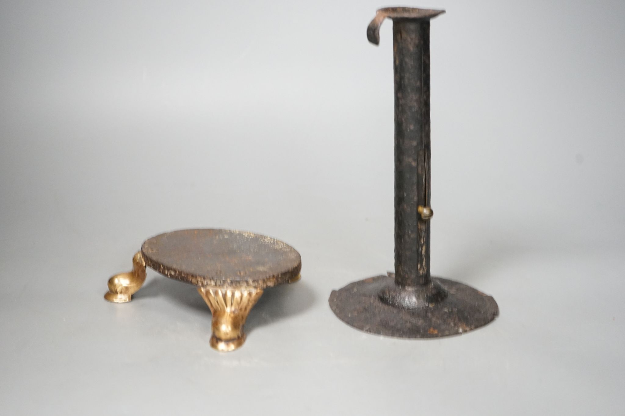 An 18th century provincial tole candlestick and an 18th century iron and brass oval stand, candlestick 20cm